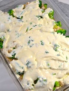 a casserole dish with broccoli and white sauce on the top is ready to be eaten