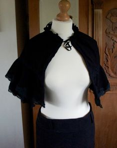 Handmade Victorian Style Black Moleskin Ladies Cropped Cape With Layered Lace Edged Detail.  The size is adjustable as the cape gathers at the neckline. This would look wonderful with a victorian gown or as an accessory with a steampunk costume. Please take a look at more wonderful original costumes and accessories available in my shop. I am regularly creating new individual items.  If you would like a custom costume please message me.  Remember to like my shop or follow me to stay updated. Than Fitted Gothic Cape For Costume, Chic Black Capelet, Elegant Black Capelet For Costume, Black Fitted Capelet, Fitted Black Capelet, Elegant Black Fitted Cape, Original Costumes