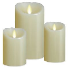 three white candles sitting next to each other