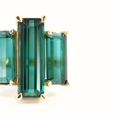 The showstopper. Three lush luxurious AA green tourmalines are set in slim claw settings and sit atop a classic round band. Classic with a twist, this art deco inspired piece makes a fantastic statement ring or a wedding piece. Spiritually, green tourmaline carries the essence of the earth and her plant kingdom. It's conducive to healing, happiness, and setting a clear & grounded direction for the future. The Details: One of a kind! Solid recycled 14k yellow gold. 9.71 total carats of AA Brazili Classic Green Tourmaline Jewelry, Elegant Emerald Cut Tourmaline Jewelry, Elegant Three Stone Tourmaline Jewelry, Elegant Emerald-cut Tourmaline Ring, Elegant Emerald Cut Tourmaline Ring, Elegant Yellow Gold Tourmaline Emerald Ring, Elegant Baguette Cut Tourmaline Jewelry, Elegant Baguette-cut Tourmaline Jewelry, Elegant Green Emerald Three Stone Ring