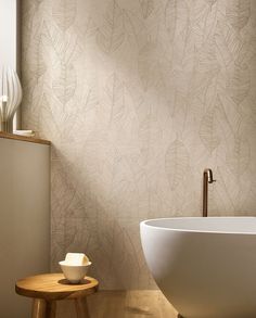 a white bath tub sitting next to a wooden table