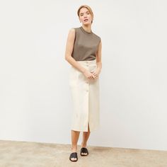 This midi-length skirt is made from a Turkish two-way stretch cotton that provides comfort, ease, and excellent recovery. Visible buttons down the front create a retro look, while hidden buttons in between prevent gaping and ensure complete coverage. A vent in the back makes for easy movement, while pockets offer a place to stash essentials. Summer Workwear Denim Skirt With Button Closure, Modern Long Pencil Skirt For Spring, Workwear Bottoms With Button Closure And Midi Length, Cotton Midi-length Workwear Bottoms, Cotton Midi-length Bottoms For Work, Cotton Midi Length Lined Pencil Skirt, Cotton Midi Bottoms For Work, Versatile Cotton Skirt With Relaxed Fit, Chic Midi Denim Skirt For Workwear