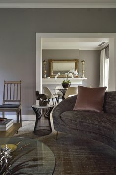 a living room filled with furniture and a fire place next to a table on top of a carpeted floor