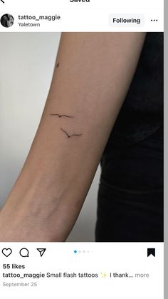 a woman's arm with a small bird tattoo on it