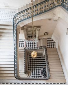 an overhead view of a stair case in a building with black and white checkered tiles