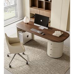 an office desk with a computer on it in front of a bookcase and bookshelf