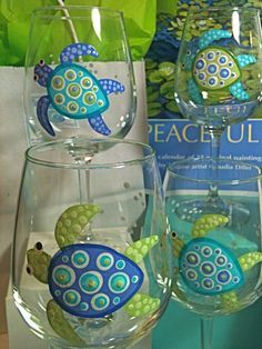 two wine glasses with sea turtles painted on them