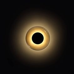 an image of a black hole in the dark with light coming from it's center