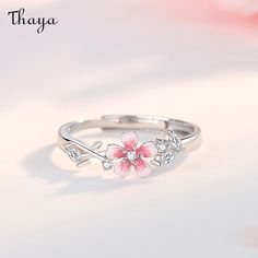 With the Sakura couple rings, celebrate your love in a traditional way. Inspired by the delicate pink blossoms and their symbolism of love and new beginnings, these rings represent a timeless promise between two hearts. Let your love bloom like the beautiful cherry blossoms.   - Brand: Thaya  - Material: S925 silver, synthetic cubic zirconia, enamel.  - Size: The widest part of the men's ring is 5.6 mm, and the widest part of the women's                   ring is 2.6 mm.  - Weight: Male 2.12g Female 1.76g  - Gender: Couple style    Open ring, adjustable, size for reference    Women's rings are suitable for the United States Size: 6-7, the inner diameter is about 16.5-17.3mm  Men's rings are suitable for US Size: 8-9, inner diameter is about 18.1-19mm Flower Promise Rings, Delicate Pink Flower Ring For Wedding, Dainty Jewelry For Anniversary In Spring, Dainty Jewelry For Spring Anniversary, Rose Gold Jewelry For Anniversary In Spring, Dainty Spring Jewelry For Anniversary, Rose Gold Jewelry For Spring Anniversary, Dainty Pink Flower Ring For Weddings, Delicate Jewelry For Anniversary In Spring