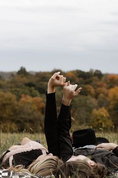 a person laying on the ground with their hands in the air