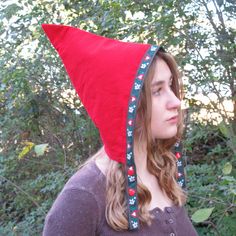 Introducing our whimsical and fun handmade pixie hats, the perfect accessory for adding a touch of magic to your winter wardrobe. These unique triangular-shaped hats are made of soft and warm red corduroy and lined with gingham check flannel for added warmth and comfort. Reversible and trimmed with playful woven jacquard ribbon ties, these hats are perfect for dress up and Pretend Play. The two sets of snaps at the chin ensure a secure fit, with no ties or bows to fuss with. Whether your child w Easy Gnome Costume, Gnome Hat Patterns, Cone Hat Diy, Diy Gnome Costume, How To Make A Gnome Hat, Diy Gnome Hat Costume, Gnome Hat Pattern, Female Gnome Costume, Fantasy Festival Costume Hats And Headpieces In Red