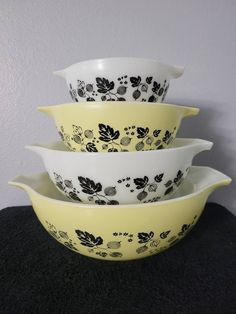 three yellow and black bowls stacked on top of each other