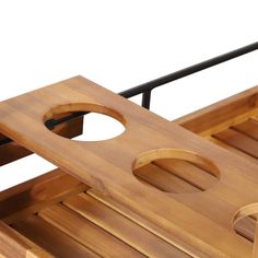 a close up of a wooden table with two holes in the middle and one hole at the top