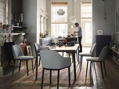 a man is standing in the middle of a dining room