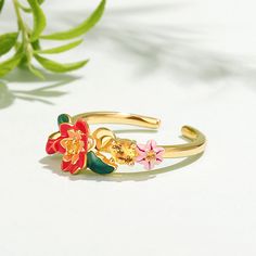 This beautifully detailed ring boasts charming flowers in bright shades of multicolored enamel. The intricate flawless enamel work coupled with sparking stones, make this an eye-catching piece.Carat Weight: 0.205 ctStone Size: 1.7,1.3,3.5 mmStone Type: Jeulia® StoneNumber of Stones: 3 Stone Shape: RoundStone Color: Citrine YellowWeight: 2.8 gWidth: 20.4 mmHeight: 5.2 mmThickness: 1 mmMaterial: 925 SilverPlating Color: Yellow Gold Yellow Gold Enamel Flower Jewelry, Yellow Gold Enamel Flower Ring Gift, Gold Enamel Flower Ring For Anniversary, Yellow Enamel Ring, Gemstone Enamel Ring, Gold Multi-stone Enamel Jewelry, Enamel Flower-shaped Jewelry For Wedding, Flower Shaped Enamel Jewelry For Wedding, Flower-shaped Enamel Jewelry For Wedding