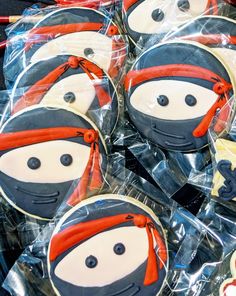 decorated cookies in the shape of people wearing hats and scarfs are on display for sale