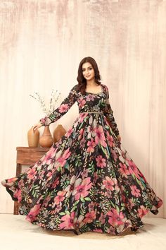 Step into elegance with our exquisite multicolor floral print Anarkali dress on a timeless black base. This resplendent ensemble boasts a magnificent flare that effortlessly captures attention. Adorned with intricate hand embroidery along the sweetheart neckline and waistline, every stitch speaks of artisanal craftsmanship and attention to detail. Crafted from pure chiffon, this Anarkali dress exudes sophistication and grace with its luxurious texture and fluid drape. Whether you're attending a wedding, festival, or any special event, this dress is the epitome of sophistication and charm. Elevate your style and make a statement with this breathtaking piece that combines tradition with contemporary flair. Tags: #AnarkaliDress #FloralPrint #HandEmbroidery #ChiffonDress #WeddingAttire #Festiv Sweetheart Neckline Anarkali, Anar Kali Dress, Long Frock Back Neck Designs, Gorget Dress Design, Floral Print Anarkali Dress, Floral Print Dress Indian, Floral Anarkali Dresses, Black Floral Gown, Cotton Anarkali Dress