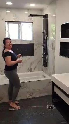 a woman standing in front of a bathroom sink