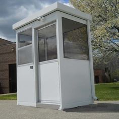 a white portable toilet sitting on top of a sidewalk