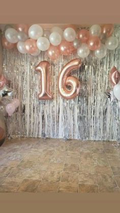 balloons and streamers are set up in the room for a 16th birthday party,