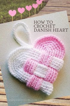 a crocheted pink and white hat on top of a card with the title how to crochet danish heart