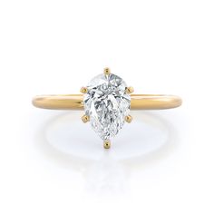 a yellow gold ring with an oval cut diamond