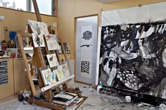 an artist's easel with paintings on it