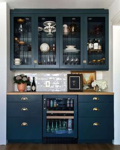 the cabinets in this kitchen are painted dark blue