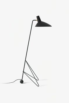 a black lamp on a white background with a cord attached to the base and one light turned on