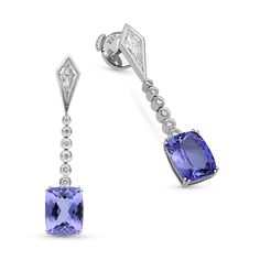 Polish off your attire with these sleek and stylish gemstone and diamond drop earrings. Created in 18K white gold, each linear earring showcases cushion cut tanzanite as the special feature of the dangle. A diamond-lined bar connects the drop to the diamond kite-shape bezel set post. 
2.25 Cushion-cut carat tanzanite
2.07 Cushion-cut carat tanzanite
0.55 carat white diamonds
18K white gold
The earring design can be customized to suit your particular taste & budg Luxury Tanzanite Jewelry With Brilliant Cut, Luxury Cushion Cut Tanzanite Jewelry, Luxury Tanzanite Earrings, Brilliant Cut Tanzanite Blue Earrings, Luxury Tanzanite Earrings With Gemstone, Emerald Earrings Drop, Tanzanite Pendant, Shiny Rings, Sapphire And Diamond Earrings