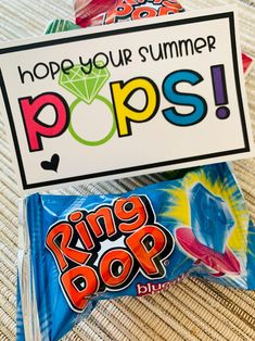 some kind of candy bag sitting on top of a table next to a sign that says, hope your summer pops