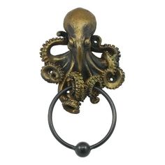 an octopus head is mounted on the handle of a door knocker, with two tentacles hanging from it's sides