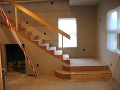 an empty room with some stairs in the process of being painted and installed to look like it is going up