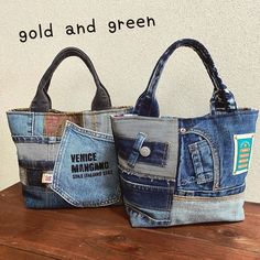 two purses made out of old jeans are sitting on top of a wooden table