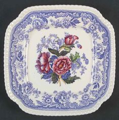 a blue and white plate with flowers on it