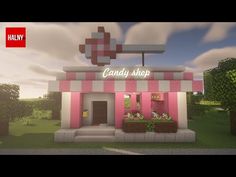 a candy shop with pink and white striped awnings