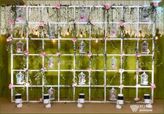 the wedding backdrop is decorated with flowers and birdcages