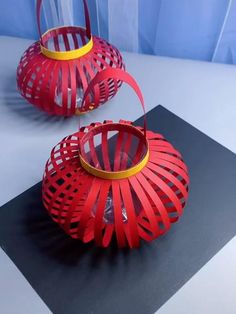 two red baskets sitting on top of a table