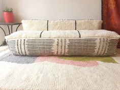 a white and black basket sitting on top of a rug