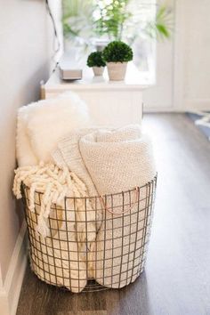 a basket sitting on the floor next to a window