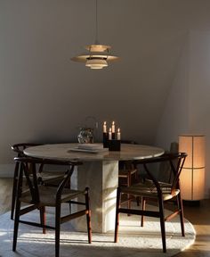 a round table with chairs around it in a room