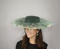 Elegant woman Kentucky derby hat green and beige. Beige and dark green wedding hat. The cream dress hat is covered with green feathers and has a suede dark green crown. It is a hat that has movement once you are walking. An elegant look for this spring special Occasions, any woman can wear it on a Morning wedding, Tea party, races, Kentucky Derby, or Ascot. The sunhat measured 46 centimeters in diameter. It is mounted on a headband that allows to tilt the sunhat to the liking of each one. If you Beige And Green Wedding, Wedding Feathers, Kentucky Derby Outfit, Dark Green Wedding, Ivory Fascinator, Green Crown, Green Fascinator, Green Feathers, Royal Ascot Hats