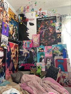 a bed covered in lots of posters next to a wall filled with pictures and other items