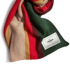 a multicolored scarf with a tag on the front and back of it, sitting against a white background