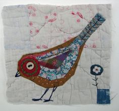 a quilted piece with a bird on it