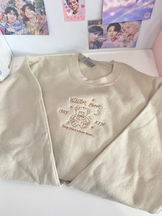 Embrace the gentle warmth of winter with the Winter Bear Beige Crewneck Sweatshirt, inspired by Taehyung's heartfelt song "Winter Bear." This sweatshirt is designed to bring you comfort and calm, just like the soothing melody that inspired it. Made from a luxuriously soft cotton blend, it features a relaxed fit that drapes effortlessly for a cozy, laid-back style. The tranquil beige color reflects the serene, snowy landscapes of winter, while delicate embroidered details on the chest pay homage Beige Crewneck, Embroidery Crewneck, Bear Embroidery, Bear Sweatshirt, Winter Bear, Collared Sweatshirt, Kpop Merch, Embroidered Hoodie, V Taehyung