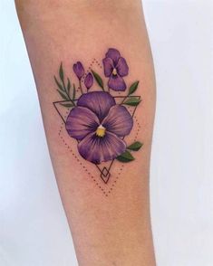 a purple flower tattoo on the leg