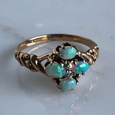 Details: Beautiful Victorian Opal and Diamond ring. There are 4 small 4mm x 3mm opals with a lot of life and color in them. The opals has blue, pink, and a touch of orange play of color and even distribution. The ring has two-2mm diamonds, that are rose cuts. Please ask all necessary questions prior to placing an order. Measurements: The size is around 6 US, and can be sized for a fee. Condition: The overall all condition of this ring is very good. Victorian Multi-stone Opal Ring As Gift, Victorian Multi-stone Opal Ring For Gift, Victorian Multi-stone Opal Ring, Heirloom Multi-stone Opal Ring, Fine Multi-stone Ethiopian Opal Ring, Vintage Multi-stone Opal Rings, Vintage Opal Multi-stone Rings, Anniversary Multi-stone Ethiopian Opal Ring, Anniversary Multi-stone Opal Ring