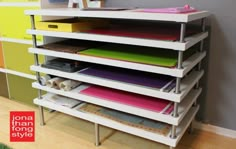 a shelf with many different colored folders on it