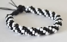 a black and white beaded bracelet on a table